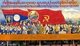 Laos: Children carry an image of Kaysone Phomvihane, President of Laos from 1991 until his death in 1992, Revolutionary Socialist realist-style political poster on the streets of Vientiane